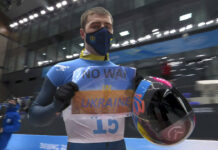 Ukraine Olympic Team Calls for Peace, IOC Wants No Protests In this frame from video, Vladyslav Heraskevych, of Ukraine, holds a sign that reads "No War in Ukraine" after finishing a run at the men's skeleton competition at the 2022 Winter Olympics, Friday, Feb. 11, 2022, in the Yanqing district of Beijing. Photo: NBC via AP