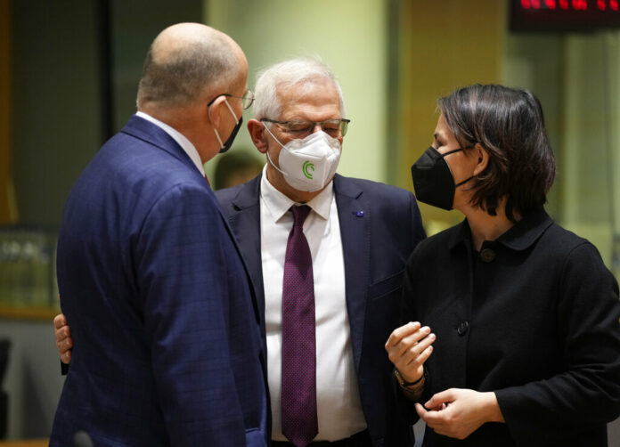 German Foreign Minister Annalena Baerbock, right, speaks with Poland's Foreign Minister Zbiegniew Rau, left, and European Union foreign policy chief Josep Borrell during a meeting of EU foreign ministers in Brussels, Monday, Feb. 21, 2022. Photo: Virginia Mayo / AP