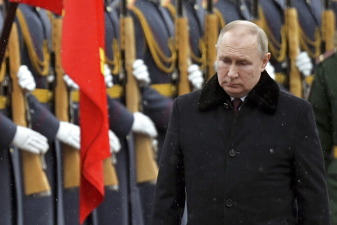 Russian President Vladimir Putin attends a wreath-laying ceremony at the Tomb of the Unknown Soldier, near the Kremlin Wall during the national celebrations of the 'Defender of the Fatherland Day' in Moscow, Russia, Wednesday, Feb. 23, 2022. Photo: Alexei Nikolsky / Kremlin Pool Photo via AP