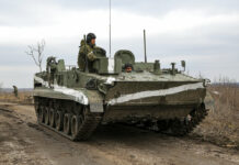 Putin Puts Nuclear Forces on High Alert, Escalating Tensions An armored vehicle rolls outside Mykolaivka, Donetsk region, the territory controlled by pro-Russian militants, in eastern Ukraine, Sunday, Feb. 27, 2022. Photo: AP