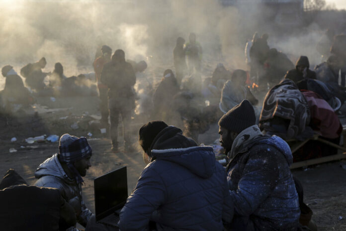 Refugees try to stay warm after fleeing the Russian invasion of Ukraine, at the Medyka border crossing in Poland, Tuesday, March 1, 2022. Photo: Visar Kryeziu / AP Refugees try to stay warm after fleeing the Russian invasion of Ukraine, at the Medyka border crossing in Poland, Tuesday, March 1, 2022. Photo: Visar Kryeziu / AP