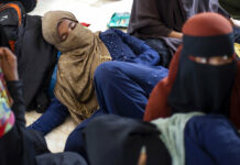 More Than 100 Rohingya Land on Beach in Indonesia’s Aceh Ethnic Rohingya people rest at a temporary shelter in Bireuen, Aceh province, Indonesia, Sunday, March 6, 2022. Photo: Zik Maulana / AP