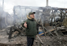 Ukraine Says Russia Steps up Shelling of Residential Areas A man opens his arms as he stands near a house destroyed in the Russian artillery shelling, in the village of Horenka close to Kyiv, Ukraine, Sunday, March 6, 2022. Photo: Efrem Lukatsky / AP