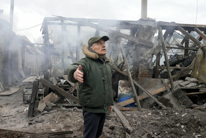 A man opens his arms as he stands near a house destroyed in the Russian artillery shelling, in the village of Horenka close to Kyiv, Ukraine, Sunday, March 6, 2022. Photo: Efrem Lukatsky / AP A man opens his arms as he stands near a house destroyed in the Russian artillery shelling, in the village of Horenka close to Kyiv, Ukraine, Sunday, March 6, 2022. Photo: Efrem Lukatsky / AP