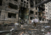 Russia Pounds Away at Ukraine as Two Sides Plan More Talks A local resident searches for his belongings in an apartment building after it was hit by artillery shelling in Kyiv, Ukraine, Monday, March 14, 2022. Photo: Vadim Ghirda / AP