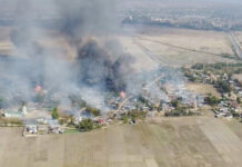 Witness: Army Attacks in Eastern Myanmar Worst in Decades In this image taken from drone video provided by Free Burma Rangers, black smoke arises from burning buildings in Waraisuplia village in Kayah State, Myanmar on Feb. 18, 2022. Photo: Free Burma Rangers via AP