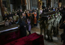 Russia Steps up Assaults as Ukraine Appeals for More Help Ukrainian soldiers carry the coffin of one of the Ukrainian military servicemen, who were killed during an airstrike on a military base in Yarokiv, during a funeral ceremony in Lviv, Ukraine, Tuesday, March 15, 2022. Photo: Bernat Armangue / AP