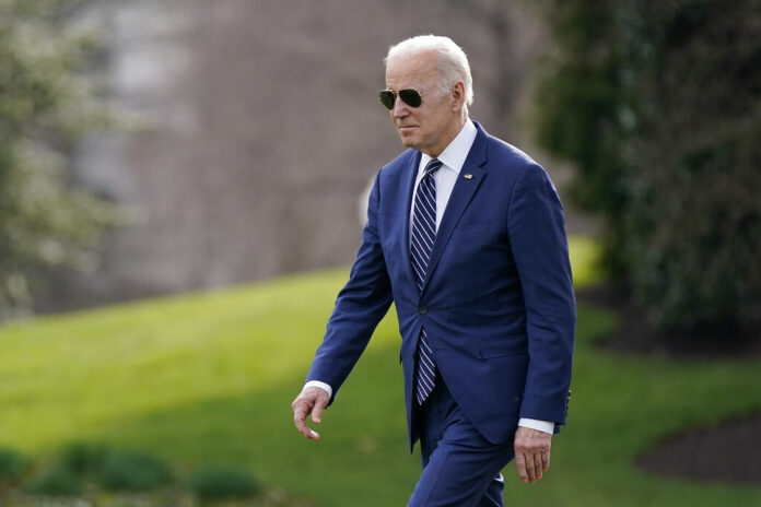 President Joe Biden walks on the South Lawn of the White House before boarding Marine One, Friday, March 18, 2022, in Washington. Biden is spending the weekend at his home in Rehoboth Beach, Del. Photo: Patrick Semansky / AP