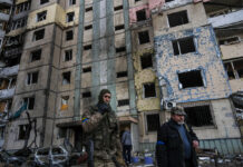 Russia Demands Mariupol Lay Down Arms but Ukraine Says No A soldier smokes a cigarette while walking next to a destroyed building after a bombing in Satoya neighborhood in Kyiv, Ukraine, Sunday, March 20, 2022. Photo: Rodrigo Abd / AP