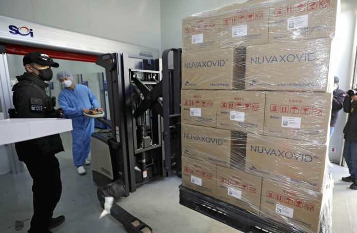 FILE - A worker moves boxes carrying Novavax's COVID-19 vaccine at SK Bioscience Co. in Andong, South Korea, on Feb. 9, 2022. Photo: Kim Hyun-tae/Yonhap via AP File