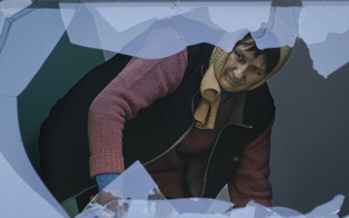 A woman cleans the staircase of broken glass at an apartment building damaged by bombing in Kyiv, Ukraine,Wednesday, March 23, 2022. Photo: Vadim Ghirda / AP