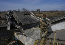 New Round of Talks Aims To Stop the Fighting in Ukraine A soldier stands on a bridge destroyed by the Ukrainian army to prevent the passage of Russian tanks near Brovary, in the outskirts of Kyiv, Ukraine, Monday, March 28, 2022. Photo: Rodrigo Abd / AP