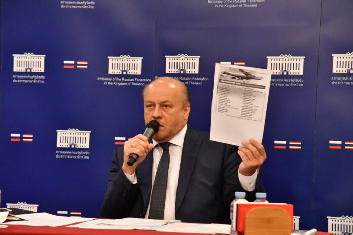 Russian ambassador to Thailand Evgeny Tomikhin holds a paper which says 