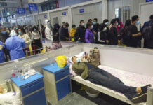Surprisingly Low Shanghai COVID Death Count Spurs Questions People who have been negative in the last two nucleic acid tests line up to leave a temporary hospital converted from the National Exhibition and Convention Center to quarantine COVID-positive people in Shanghai, China on April 18, 2022. Photo: Chinatopix via AP