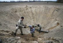 Russia Hits Ukrainian Cities, Pours More Troops Into War Interior ministry sappers collect explosives in a hole to detonate them near a mine field after recent battles at the village of Moshchun close to Kyiv, Ukraine, Tuesday, April 19, 2022. Photo: Efrem Lukatsky / AP