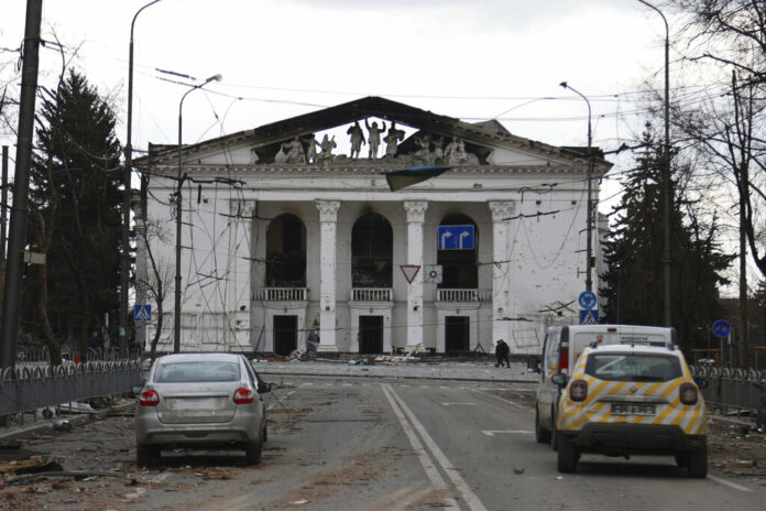 FILE - People walk past the Donetsk Academic Regional Drama Theatre in Mariupol, Ukraine, following a March 16, 2022, bombing of the theater, which was used as a shelter, in an area now controlled by Russian forces on Monday, April 4. Photo: Alexei Alexandrov / AP File