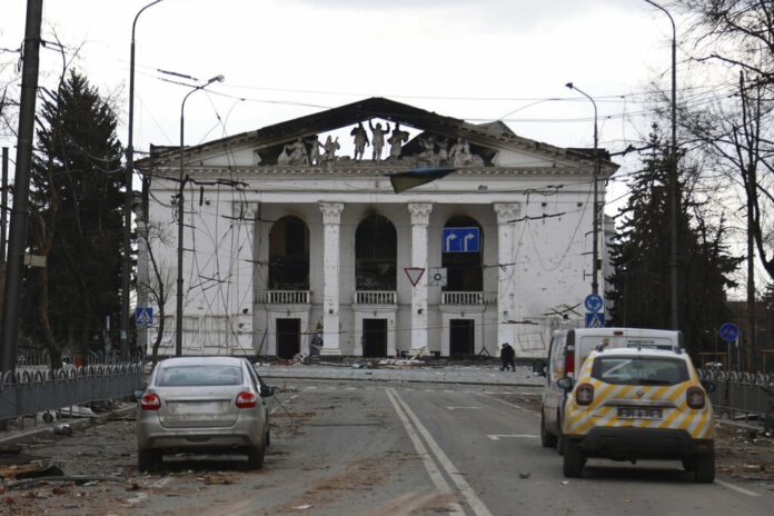 FILE - People walk past the Donetsk Academic Regional Drama Theatre in Mariupol, Ukraine, following a March 16, 2022, bombing of the theater, which was used as a shelter, in an area now controlled by Russian forces on Monday, April 4. Photo: Alexei Alexandrov / AP File FILE - People walk past the Donetsk Academic Regional Drama Theatre in Mariupol, Ukraine, following a March 16, 2022, bombing of the theater, which was used as a shelter, in an area now controlled by Russian forces on Monday, April 4. Photo: Alexei Alexandrov / AP File