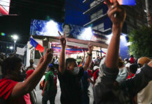 Marcos Jr. Won Philippine Presidency, Unofficial Count Shows Supporters flash signs as they arrive at the headquarters of Ferdinand "Bongbong" Marcos, Jr. in Mandaluyong, Philippines late Monday, May 9, 2022. Photo: Aaron Favila / AP