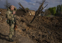 Ukrainians Make Gains in East, Hold On at Mariupol Mill A Ukrainian serviceman inspects a site after an airstrike by Russian forces in Bahmut, Ukraine, Tuesday, May 10, 2022. Photo: Evgeniy Maloletka / AP