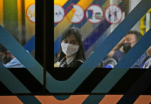 Indonesia Lifts Outdoor Mask Mandate as COVID-19 Wanes A woman wearing a mask to curb the spread of coronavirus sits inside a bus in Jakarta, Indonesia, Tuesday, May 17, 2022. Photo: Dita Alangkara / AP