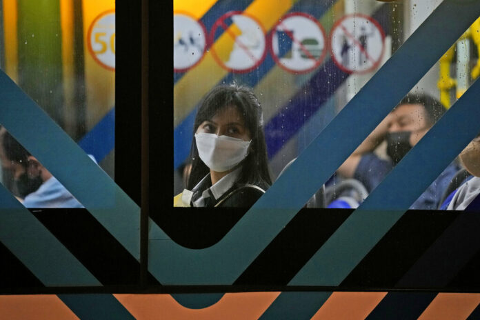 A woman wearing a mask to curb the spread of coronavirus sits inside a bus in Jakarta, Indonesia, Tuesday, May 17, 2022. Photo: Dita Alangkara / AP A woman wearing a mask to curb the spread of coronavirus sits inside a bus in Jakarta, Indonesia, Tuesday, May 17, 2022. Photo: Dita Alangkara / AP