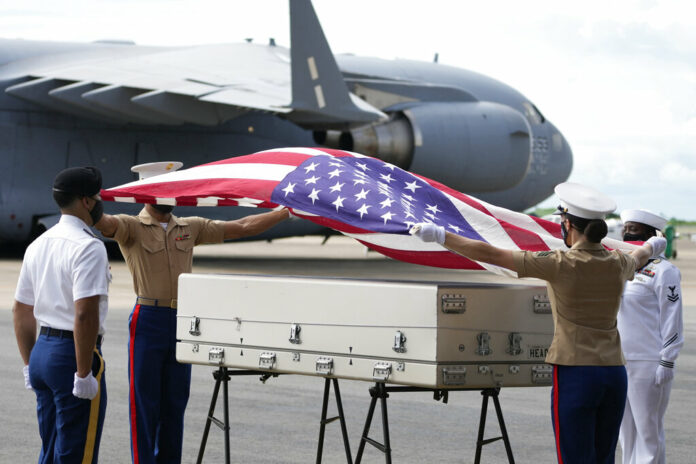 U.S. military drape a national flag over the possible remains of a WWII U.S. airman found in northern Thailand, during a repatriation ceremony Wednesday, May 18, 2022, at the U-Tapao Air Base in Rayong province, eastern Thailand. Photo: Sakchai Lalit / AP U.S. military drape a national flag over the possible remains of a WWII U.S. airman found in northern Thailand, during a repatriation ceremony Wednesday, May 18, 2022, at the U-Tapao Air Base in Rayong province, eastern Thailand. Photo: Sakchai Lalit / AP