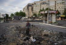 Troops Who Defended Mariupol Steel Mill Registered as POWs A man searches for metal scraps in a shelled neighbourhood in Kharkiv, eastern Ukraine, Thursday, May 19, 2022. Photo: Bernat Armangue / AP