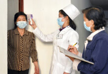 N. Korea’s Low Death Count Questioned Amid COVID-19 Outbreak FILE - In this photo provided by the North Korean government, a doctor checks a resident's temperature to curb the spread of coronavirus infection, in Pyongyang, North Korea on May 17, 2022. Photo: Korean Central News Agency / Korea News Service via AP File
