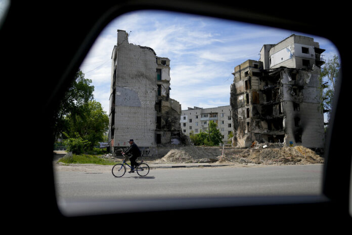 A man rides a bicycle in front of a building ruined by shelling in Borodyanka, on the outskirts of Kyiv, Ukraine, Wednesday, May 25, 2022. Photo: Natacha Pisarenko / AP A man rides a bicycle in front of a building ruined by shelling in Borodyanka, on the outskirts of Kyiv, Ukraine, Wednesday, May 25, 2022. Photo: Natacha Pisarenko / AP