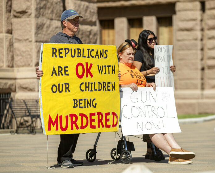 People hold signs during a protest at the Capitol in Austin, Texas, on Wednesday May 25, 2022, after a mass shooting at an elementary school in Uvalde. Photo: Jay Janner / Austin American-Statesman via AP