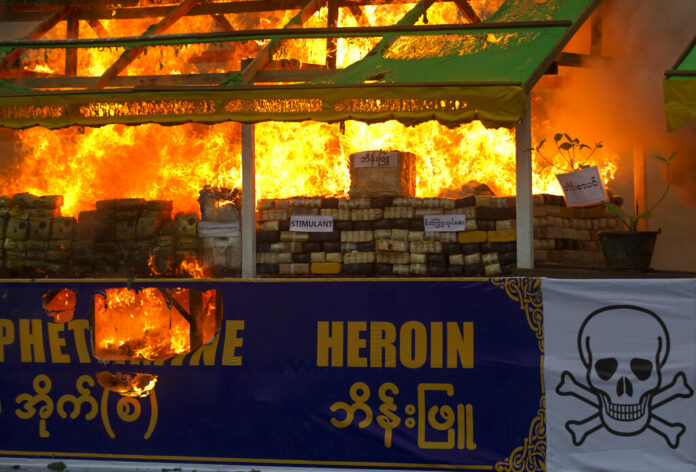 FILE - Smokes and flames billow from burning narcotic drugs during a destruction ceremony of seized narcotic drugs in outskirts of Yangon, Myanmar on June 26, 2018. Photo: Thein Zaw / AP File FILE - Smokes and flames billow from burning narcotic drugs during a destruction ceremony of seized narcotic drugs in outskirts of Yangon, Myanmar on June 26, 2018. Photo: Thein Zaw / AP File