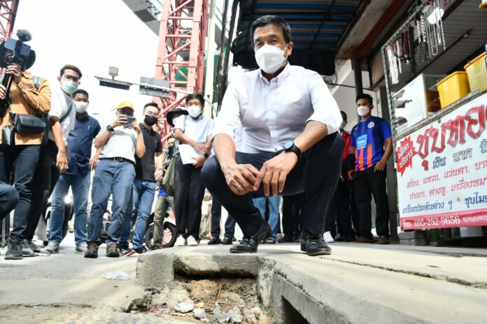 Bangkok Governor-elect Chadchart Sittipunt inspects damaged pavement at Bang Kapi's Lam Sali Intersection on May 25, 2022.