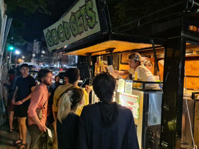 Customers queue up to buy buds at Panusith's cannabis truck on Khaosan Road on June 22, 2022.