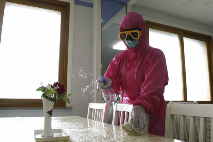 FILE - An employee of Pyongyang Dental Hygiene Products Factory disinfects the floor of a dinning room as the state increased measures to stop the spread of illness in Pyongyang, North Korea, May 16, 2022. Photo: Cha Song Ho / AP File