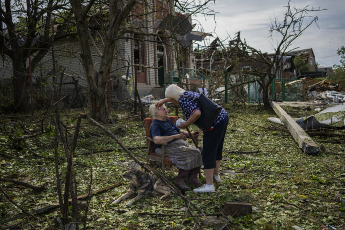 Elena Holovko sits among debris outside her house damaged after a missile strike in Druzhkivka, eastern Ukraine, Sunday, June 5, 2022. Photo: Bernat Armangue / AP