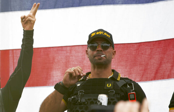 FILE - Proud Boys leader Enrique Tarrio wears a hat that says The War Boys and smokes a cigarette at a rally in Delta Park on Sept. 26, 2020, in Portland, Ore. Photo: Allison Dinner / AP File