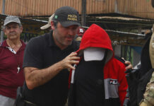 Police: Amazon Fisherman Confesses To Killing Missing Pair A federal police officer escorts a suspect towards a river in the area where Indigenous expert Bruno Pereira and freelance British journalist Dom Phillips disappeared, in Atalaia do Norte, Amazonas state, Brazil, Wednesday, June 15, 2022. Photo: Edmar Barros / AP