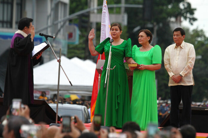 Sara Duterte, the daughter of outgoing populist president of the Philippines, takes her oath as vice president during rites in her hometown in Davao city, southern Philippines, Sunday June 19, 2022. Photo: Manman Dejeto / AP