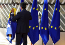 Moldova, Tiny, Poor and Bordering Ukraine, Gets EU Candidacy A member of protocol sets out EU and other flags prior to arrivals for an EU summit in Brussels, Thursday, June 23, 2022. Photo: Olivier Matthys / AP