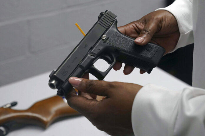 FILE - A handgun from a collection of illegal guns is reviewed during a gun buyback event in Brooklyn, N.Y., May 22, 2021. Photo: Bebeto Matthews / AP FIle