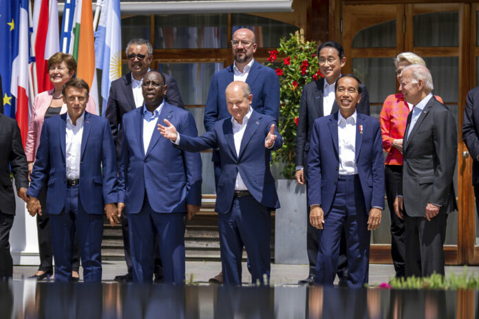 German Chancellor Olaf Scholz, centre stands between from foreground left, Emmanuel Macron, President of France, Macky Sall, President of Senegal, Jako Widodo, President of Indonesia, and U.S. President Joe Biden for a group photo with the outreach guests, at the G7 summit, in Kruen, Germany, Monday, June 27, 2022. Photo: Michael Kappeler / Pool Photo via AP German Chancellor Olaf Scholz, centre stands between from foreground left, Emmanuel Macron, President of France, Macky Sall, President of Senegal, Jako Widodo, President of Indonesia, and U.S. President Joe Biden for a group photo with the outreach guests, at the G7 summit, in Kruen, Germany, Monday, June 27, 2022. Photo: Michael Kappeler / Pool Photo via AP