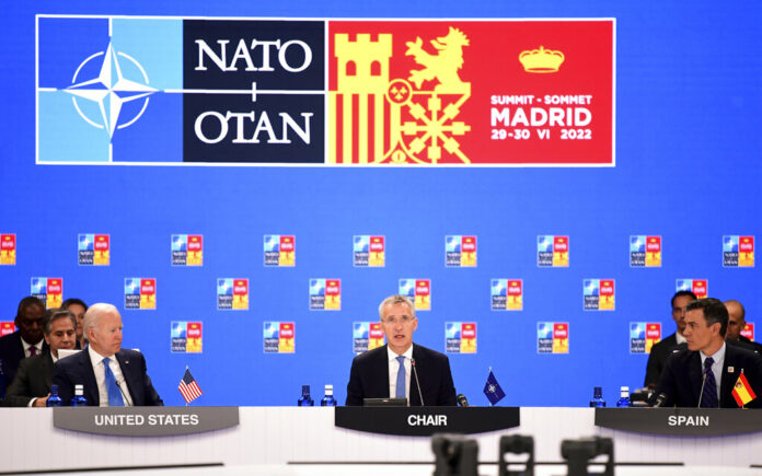 NATO Secretary General Jens Stoltenberg center, flanked by Spanish Prime Minister Pedro Sanchez, right, and U.S President Joe Biden open the first plenary session of the NATO summit in Madrid, Wednesday, June 29, 2022. Photo: Bertrand Guay / Pool via AP