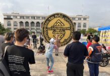 Opinion: June 24, 1932: Ninety Years of an Unfinished Revolt A woman poses with a replica of the 1932 Revolution plaque during a rally marking the 90th anniversary of the 1932 coup at Lan Khon Mueang Town Square on June 24, 2022.