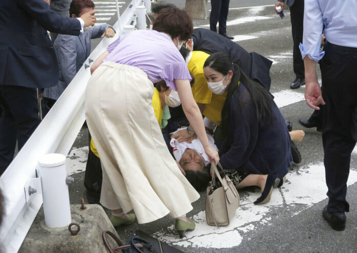 Japan’s former Prime Minister Shinzo Abe, center, falls on the ground in Nara, western Japan Friday, July 8, 2022. Photo: Kyodo News via AP Japan’s former Prime Minister Shinzo Abe, center, falls on the ground in Nara, western Japan Friday, July 8, 2022. Photo: Kyodo News via AP
