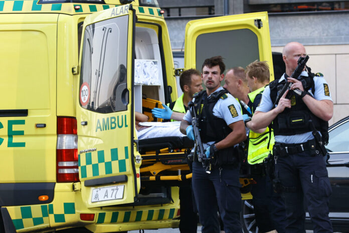 An ambulance and armed police outside the Field's shopping center, in Orestad, Copenhagen, Denmark, Sunday, July 3, 2022, after reports of shots fired. Photo: Olafur Steinar Gestsson / Ritzau Scanpix via AP