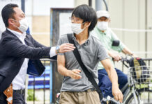 Abe’s Killing Haunts Japan With Questions on Homemade Guns FILE - Tetsuya Yamagami, center, holding a weapon, is detained near the site of gunshots in Nara, western Japan, Friday, July 8, 2022. The 40-centimeter-long (16-inch) firearm that was used to kill former Prime Minister Shinzo Abe on Friday as he campaigned for his ruling party in Nara, western Japan, looked crude, more like a propellant made of pipes taped together and filled with explosives. Photo: Nara Shimbun / Kyodo News via AP File