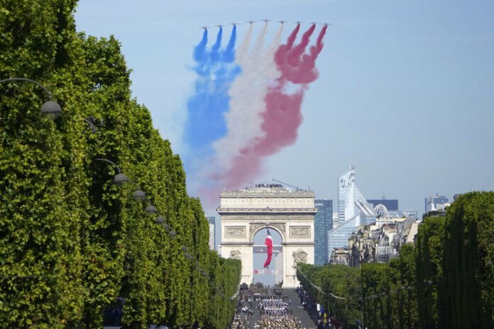 Alphajets of the Patrouille de France fly over the Champs-Elysees avenue during the Bastille Day parade Thursday, July 14, 2022 in Paris. Photo: Christophe Ena / AP