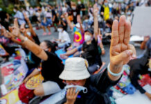 Researchers Say Thai Pro-democracy Activists Hit by Spyware FILE - Pro-democracy activists flash a three-fingered symbol or resistance during a rally in Bangkok, Thailand, on March 24, 2021. Photo: Sakchai Lalit / AP File