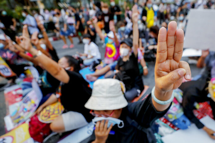 FILE - Pro-democracy activists flash a three-fingered symbol or resistance during a rally in Bangkok, Thailand, on March 24, 2021. Photo: Sakchai Lalit / AP File