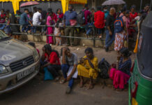 Sri Lanka’s Political Turmoil Sows Worries for Recovery People wait in queue to get their passports outside Department of Immigration & Emigration in Colombo, Sri Lanka, Monday, July 18, 2022. Photo: Rafiq Maqbool / AP